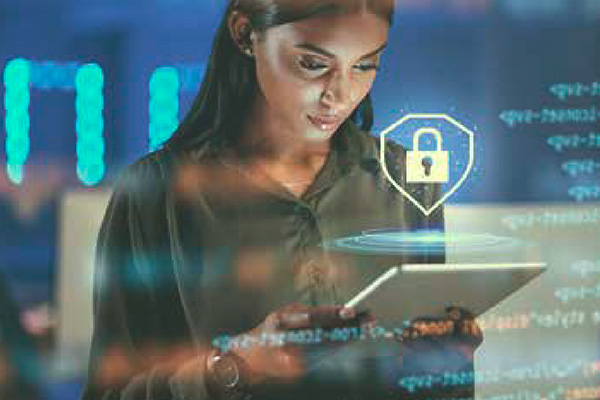 A focused woman using a tablet with a digital padlock symbol projected in front of her, indicating cybersecurity themes, against a backdrop of abstract data patterns.