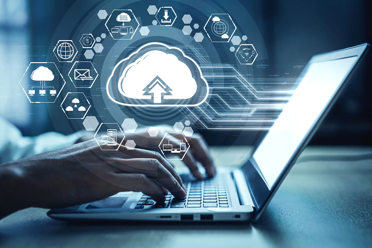 A person typing on a laptop with a graphic overlay showing cloud icons and digital connections, symbolizing data upload and cloud computing.